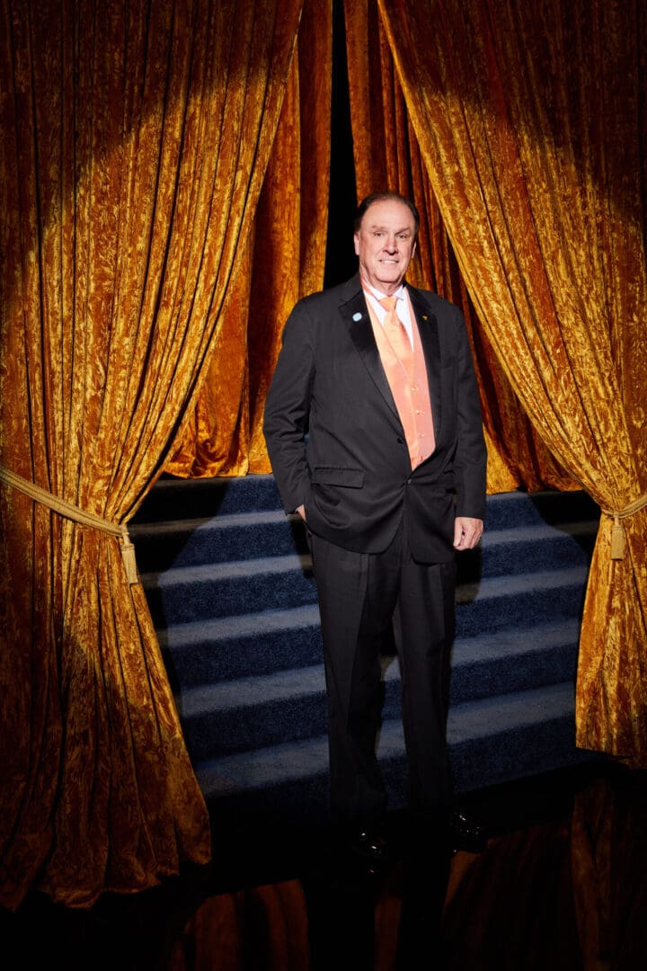 A man on the stage standing in the spotlight