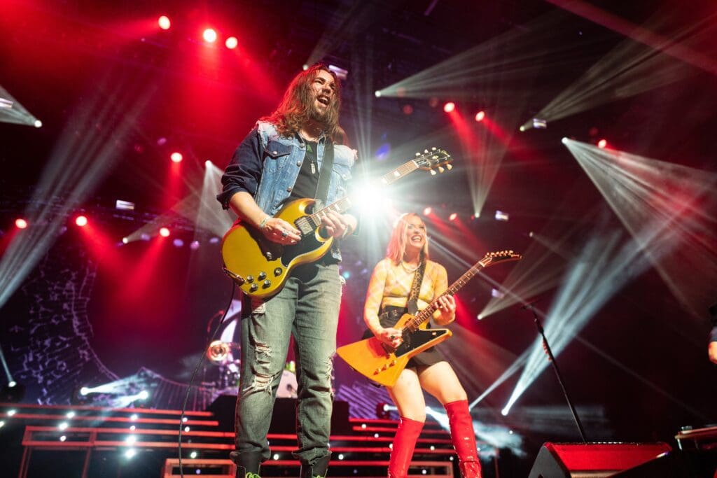 Man and girl playing guitar and singing