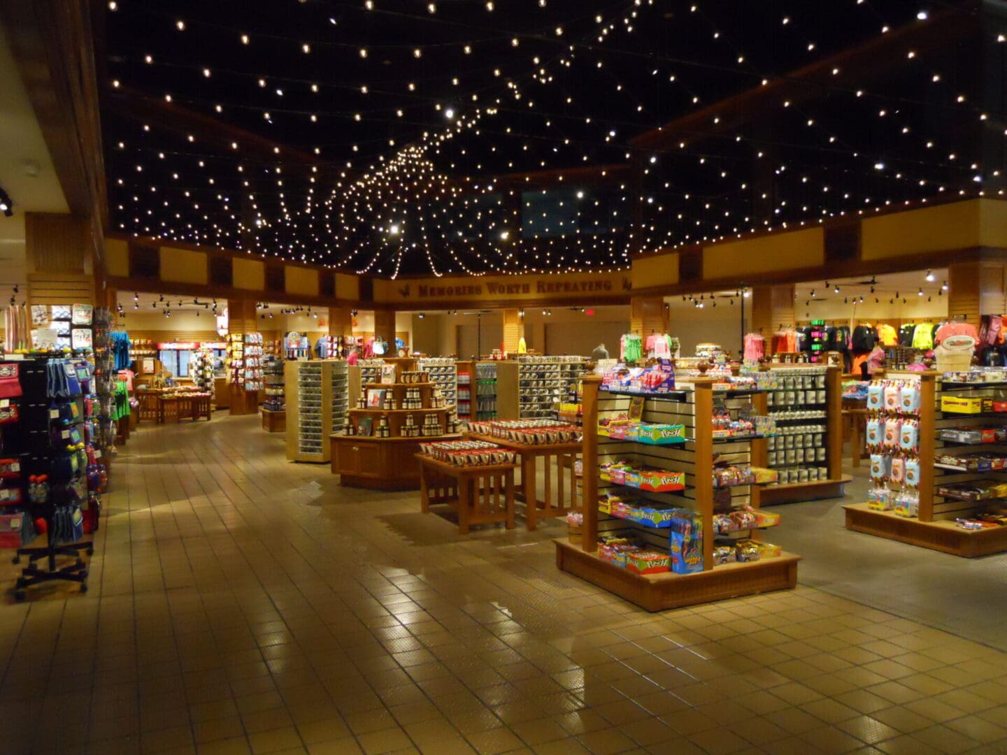 Spacious gift shop with wooden displays and string lights.