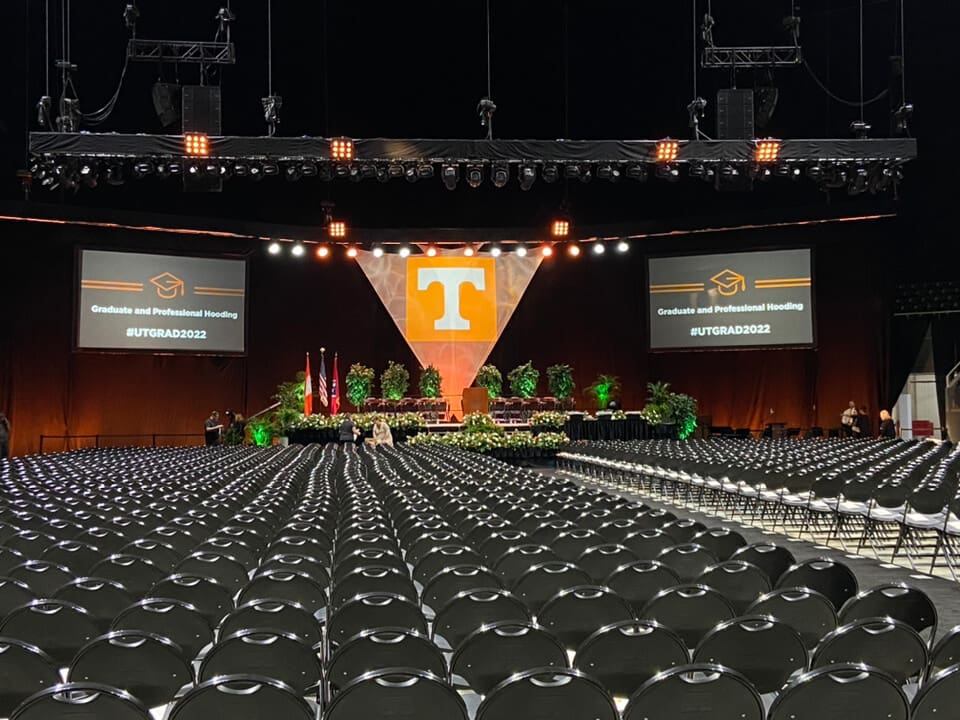 an empty hall with two big screens