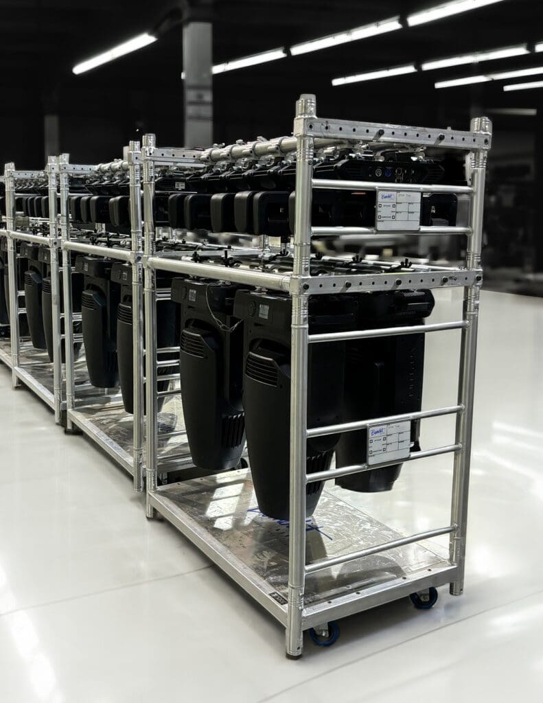 Metal rack holding multiple computer cases in a warehouse.