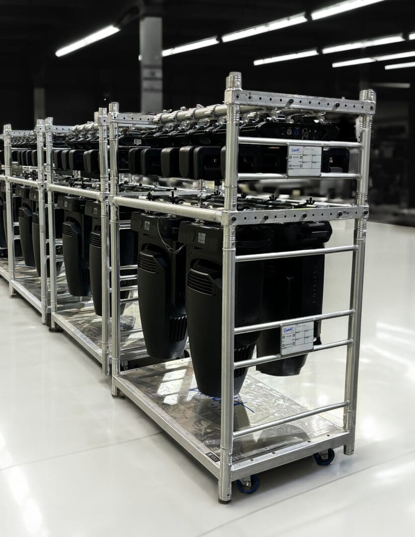Metal rack holding multiple computer cases in a warehouse.