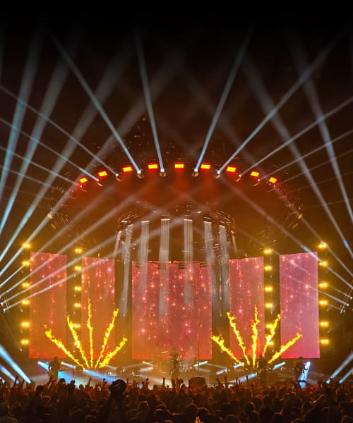 Vibrant concert stage illuminated with colorful lights and beams.