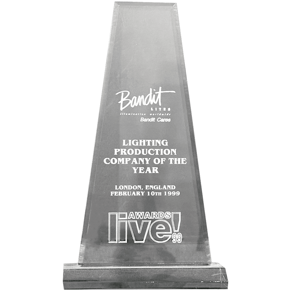 A glass award trophy with engraved text for lighting production company.