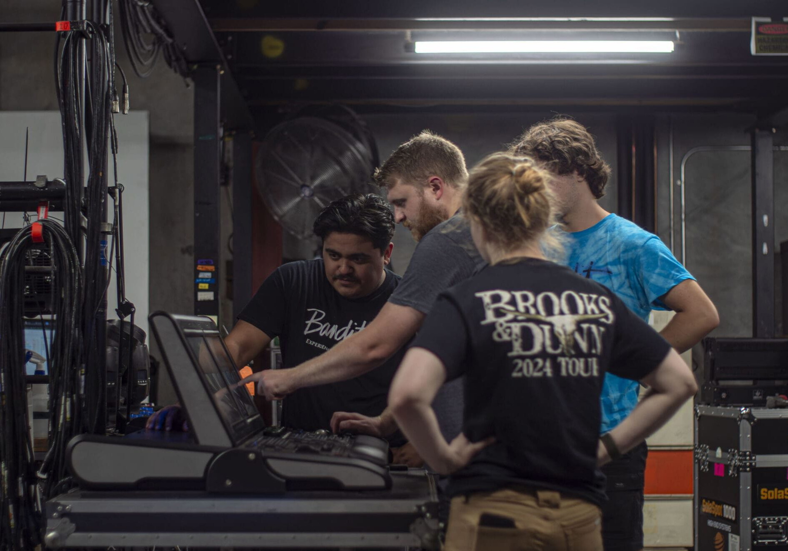 A group of young adults working together on a project indoors. A group of young adults working together on a project indoors.