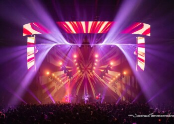 A vibrant concert stage illuminated with colorful lights and LED screens.