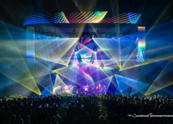Colorful light show over a crowded concert stage.