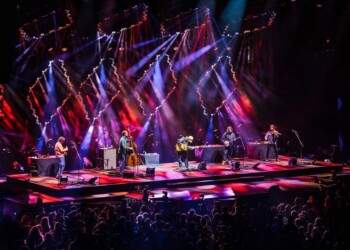 A vibrant live concert with colorful stage lights and musicians performing.