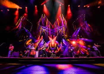 Dynamic stage performance with vibrant lighting and dancers.