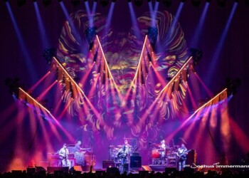 Vibrant live concert with colorful stage lights and band performing.