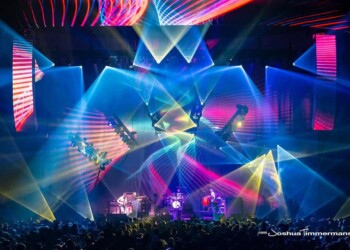 A vibrant live concert with colorful lights and laser effects.