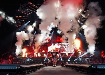 A live concert with pyrotechnics and bright stage lights.