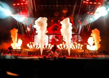 A dynamic rock concert with pyrotechnics and dramatic lighting.