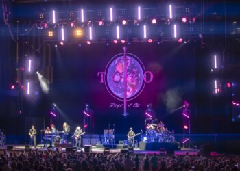 A vibrant live concert with colorful lights and a large audience.