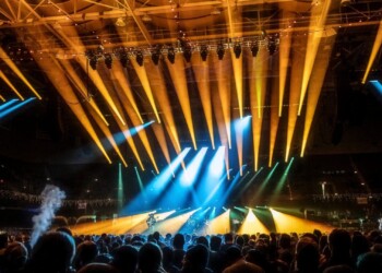 Warren Haynes Christmas Jam 2025 Vibrant stage lighting beams over a concert crowd at night.